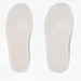 Two white shoe insoles shown side by side on a light background showing width differences. Both insoles have a textured tread pattern and a circular goat-head logo near the center.