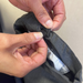 Close up of inner waistband of school trousers. Showing the internal sensory-friendly hidden waist adjuster being adjusted in a demonstration image