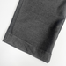Close-up of charcoal school trouser hem on a white background. Hem is adjustable.