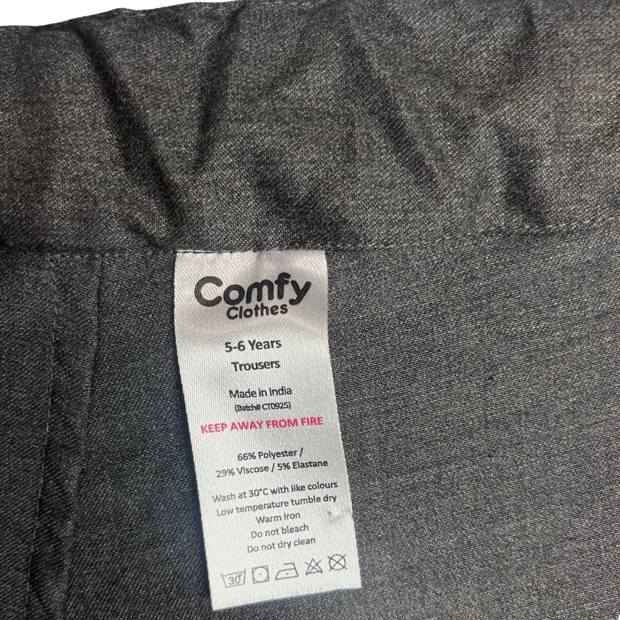 Close up of clothing tag in trousers. Tag is removable