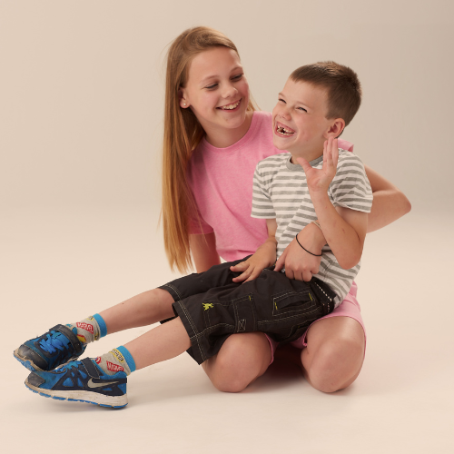 All clothing - picture of a young girl with a young boy on her lap, smiling