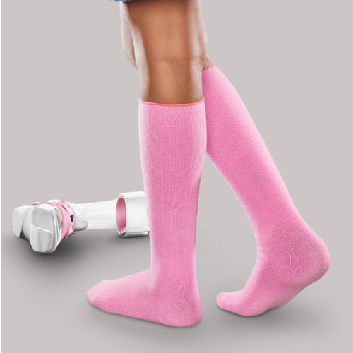 Seamless orthotic socks - picture of a girl wearing pink socks and an orthotic on the floor